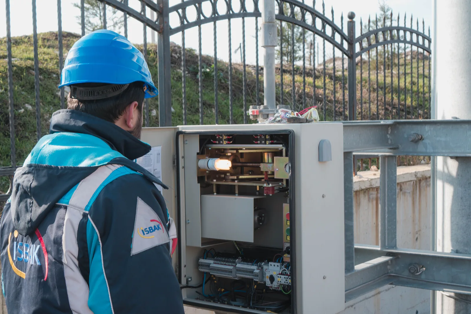 A technician checking the control panel of a pumped station