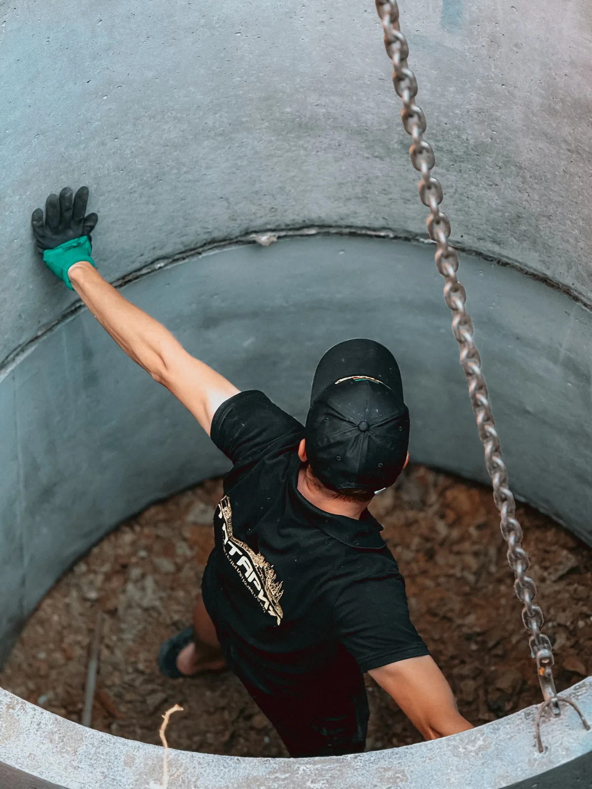 A technician working inside a newly set concrete chamber